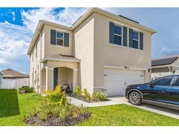 Two-story house with a garage and landscaped lawn at 1839 Wild Rye Way, Kissimmee, FL 34744