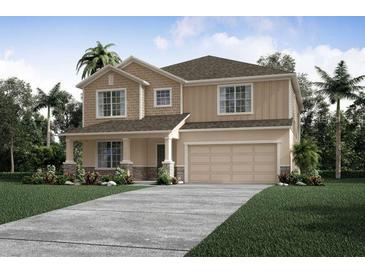 Two-story home with beige exterior and stone accents at 1629 Andover Ridge Dr, Deland, FL 32720