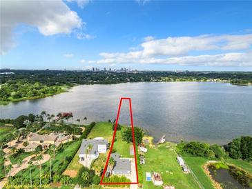 Lakefront property with city skyline view at 33 S Ortman Dr, Orlando, FL 32805