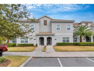 Two-story townhome with a well-manicured lawn at 4838 Romeo Cir, Kissimmee, FL 34746