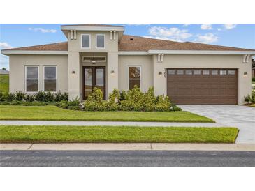 One-story home with two-car garage and landscaped yard at 169 Valencia Ridge Dr, Auburndale, FL 33823
