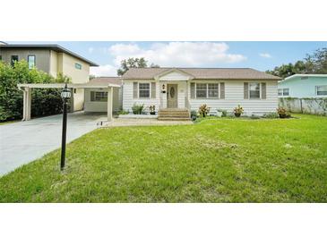 Charming single-story home with a carport and well-maintained lawn at 1338 Vassar St, Orlando, FL 32804