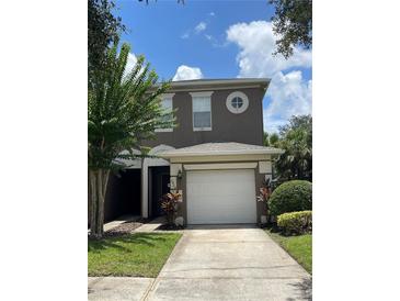 Two-story house with a white garage door at 10420 Kiplinger Ln # 238, Orlando, FL 32829
