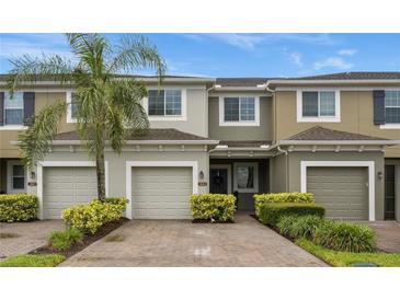 Two-story townhome with two-car garage and lush landscaping at 2663 River Landing Dr, Sanford, FL 32771