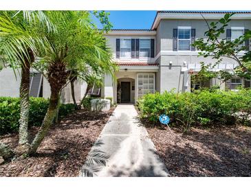 Townhouse exterior with walkway and landscaping at 4527 Alberto Cir, Kissimmee, FL 34746