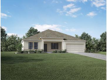Single-story home with a two-car garage and well-maintained landscaping at Unknown Arthur Ave, Edgewater, FL 32141