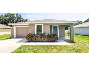 Charming house exterior with gray siding, garage, and landscaping at 888 Old Winter Haven Rd, Auburndale, FL 33823
