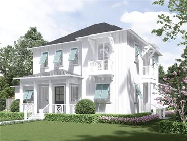 Two-story home with white siding, light blue shutters, and a manicured lawn at 511 Briley Ave, Oakland, FL 34760