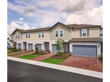 Row of townhouses with attached garages and landscaping at 2021 Crape Jasmine Ln, Orlando, FL 32824