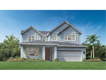 Two-story home with gray siding and a two-car garage at 1718 Pinecliff Dr, Apopka, FL 32703