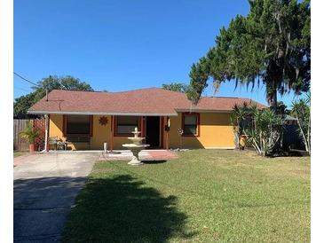 Ranch style home with mature landscaping and a fountain at 709 N Disston, Tavares, FL 32778