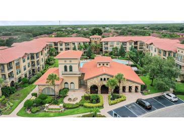 Aerial view of community with pool and clubhouse at 901 Charo Pkwy # 732, Davenport, FL 33897