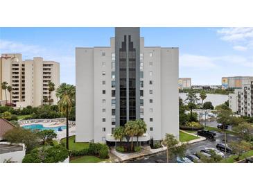 High rise building exterior with pool and surrounding landscape at 6165 Carrier Dr # 1206, Orlando, FL 32819