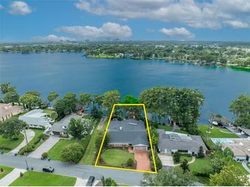 Lakefront property offering breathtaking water views and lush landscaping at 279 Rippling Ln, Winter Park, FL 32789