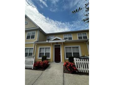 Front view of charming townhome with white picket fence at 4000 Santa Maria Dr # 105, Kissimmee, FL 34741