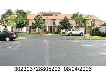 Building exterior with parking lot and landscaping at 2909 Clubview # 2909, Orlando, FL 32822
