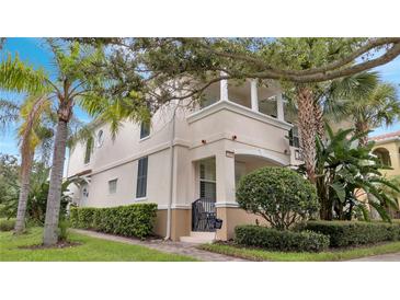 Two-story house with light-colored walls, shutters, and a balcony at 11886 Nautica Dr, Orlando, FL 32827