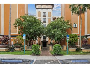 Condo building exterior with landscaping and parking at 12527 Floridays Resort Dr # 312-E, Orlando, FL 32821