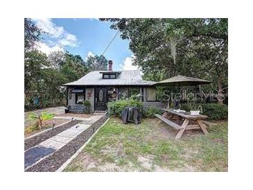 Quaint house exterior with a charming front yard and patio at 1079 Marion St, Lake Helen, FL 32744