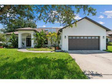 Single-story home with a two-car garage and solar panels at 4901 Culdesac Ct, St Cloud, FL 34772
