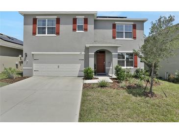 Two-story house with gray siding and red shutters at 209 Sofia Ln, Lake Alfred, FL 33850
