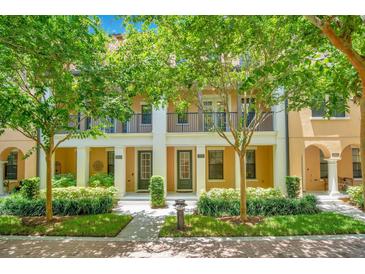 Two-story townhouses with lush landscaping and brick walkways at 2159 Bosque Aly, Orlando, FL 32814