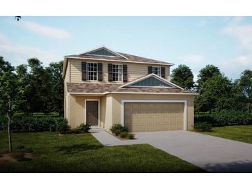 Two-story house with a beige exterior and a two-car garage at 1701 Andover Ridge Dr, Deland, FL 32720