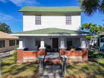 Two-story house with green roof and brick facade at 610 S Laurel Ave, Sanford, FL 32771