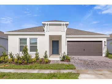 One-story home with a two-car garage and well-manicured landscaping at 4945 Worchester Dr, Kissimmee, FL 34746