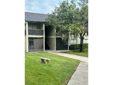 Condo building exterior with landscaping at 914 Lake Destiny Rd # H, Altamonte Springs, FL 32714
