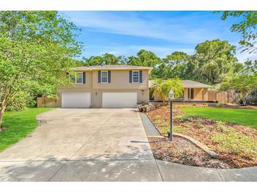 Two-story house with a large driveway and landscaped yard at 121 Candlewick Rd, Altamonte Springs, FL 32714