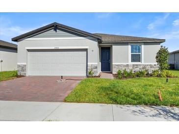 Two-car garage and a well-maintained lawn at 2482 Leeds St, Haines City, FL 33844