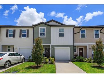 Two-story townhome with two-car garage and landscaping at 190 Mandovi St, Davenport, FL 33837