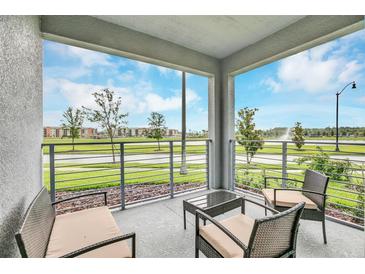 Spacious balcony with water views and comfortable seating at 4721 Clock Tower Dr # 108, Kissimmee, FL 34746