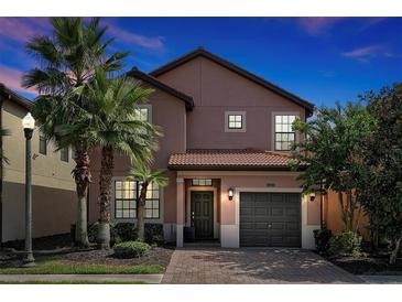Two-story house with a gray door and brown roof at 5424 Solterra Cir # 1, Davenport, FL 33837