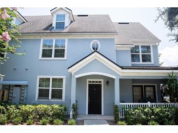 Two-story light blue home with a black door and white trim at 3478 Westchester Square Blvd # 202, Orlando, FL 32835