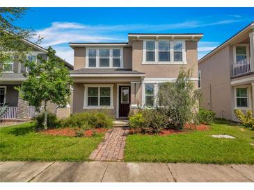 Two-story home with neutral exterior and landscaping at 8217 De Haven Street, Orlando, FL 32832