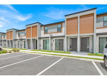 Modern townhouses with attractive exterior finishes and parking at 8775 Zen Dr, Kissimmee, FL 34747