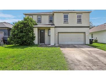 Two-story house with gray siding, double car garage, and manicured lawn at 2548 Lyndscape St, Orlando, FL 32833