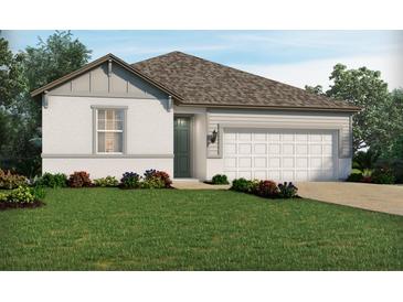 One-story home with a two-car garage and landscaped yard at 3101 Legends Preserve Dr, Daytona Beach, FL 32124