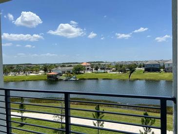 View of lake, community amenities, and houses at 3141 Paradox Cir # 306, Kissimmee, FL 34746