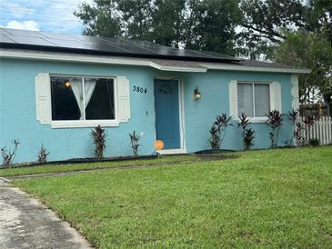 Charming light blue house with solar panels at 3804 Janie Ct, Orlando, FL 32822