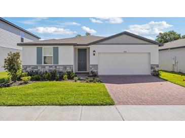 New construction home with brick facade and 2-car garage at 3506 Rutland Ln, Haines City, FL 33844