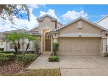 Attractive single-story home with a two-car garage and landscaped front yard at 320 Henley Cir, Davenport, FL 33896