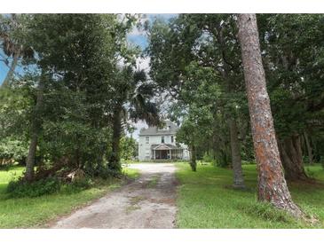 Charming house nestled among mature trees, offering privacy and curb appeal at 2341 Celery Ave, Sanford, FL 32771