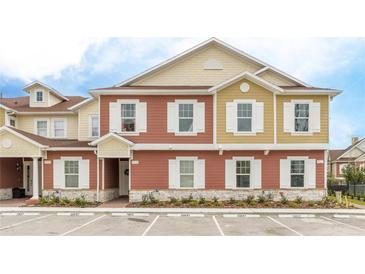 Modern two-story townhome with neutral color palette and guest parking at 7525 Sunflower Cir, Kissimmee, FL 34747