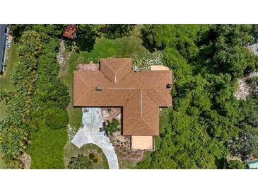 Aerial view of a single-Gathering home with a large lot and mature trees at 10611 Jim Edwards Rd, Haines City, FL 33844