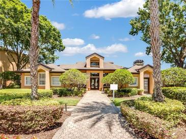 Community building with landscaping and walkway at 7524 Seurat St # 12301, Orlando, FL 32819