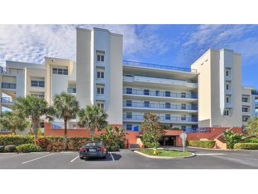 Exterior view of a multi-story building with parking and landscaping at 5300 S Atlantic Ave # 16-602, New Smyrna Beach, FL 32169