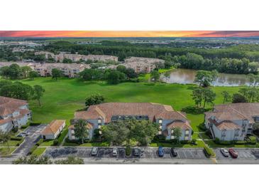 Community view with lush green space and lake at 14037 Fairway Island Dr # 233, Orlando, FL 32837